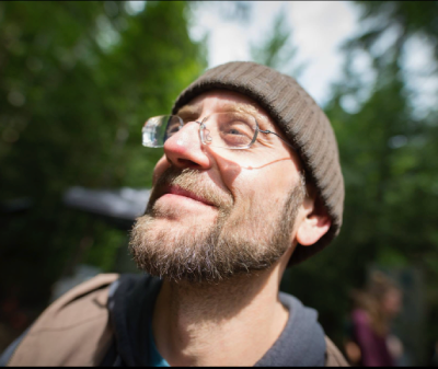 Matt, wearing glasses and a beanie outdoors